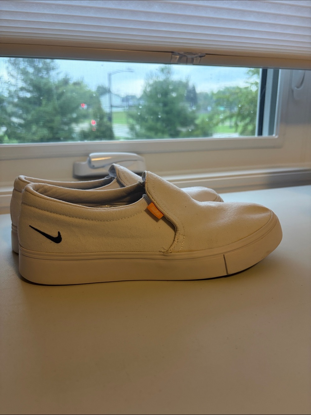 Nike White Slip-On Sneakers with Black Swoosh